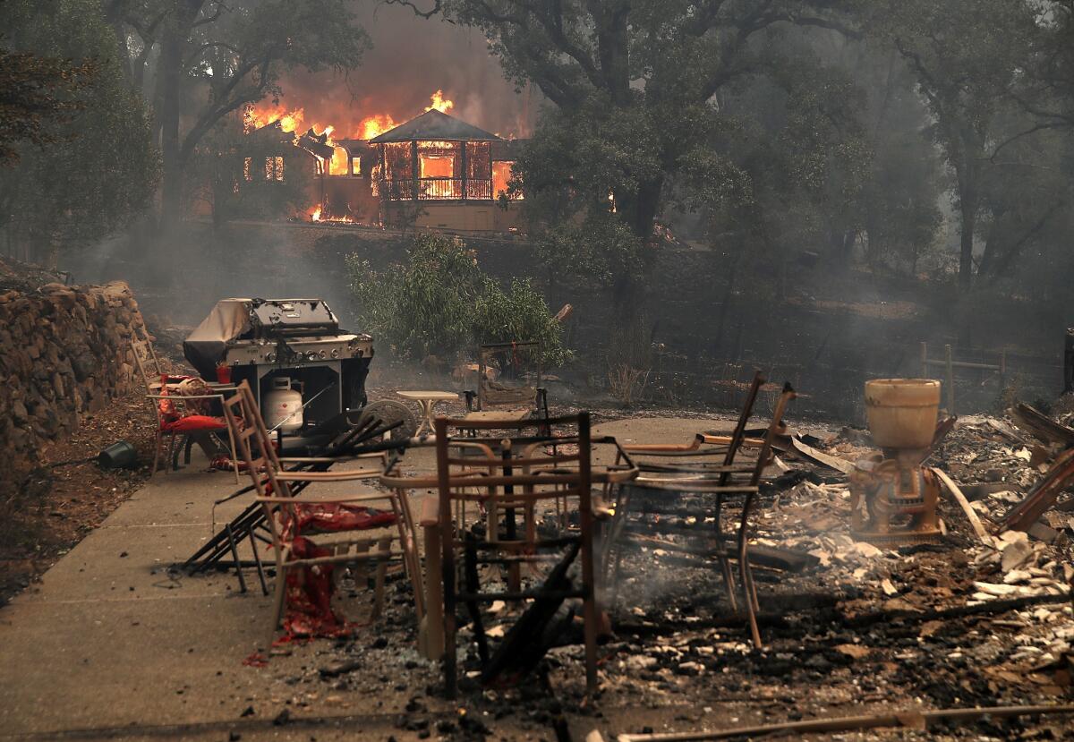 Fire consumes a home as out of control wildfires move through the area Monday in Glen Ellen, Calif.