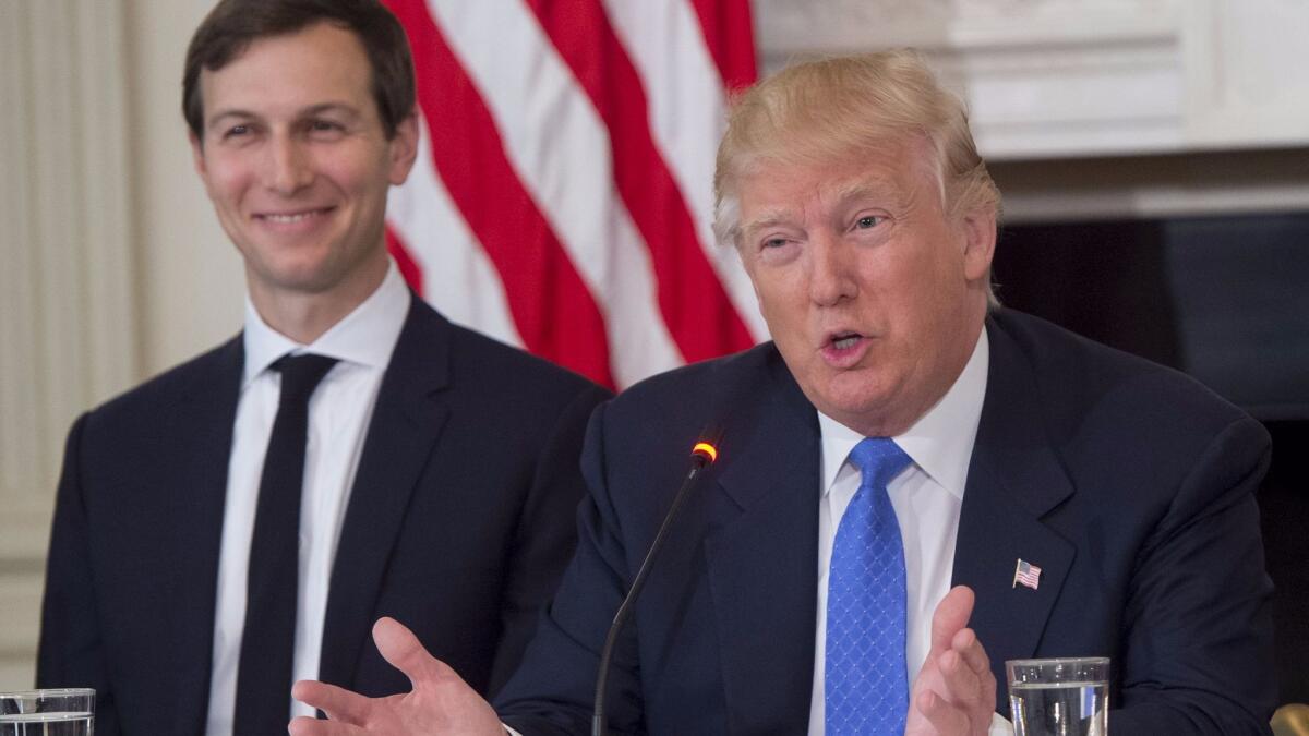 Jared Kushner, left -- President Trump's son-in-law and senior advisor -- is shown with Trump on Feb. 23. Kushner is to lead the White House Office of American Innovation. (Saul Loeb / AFP/Getty Images)
