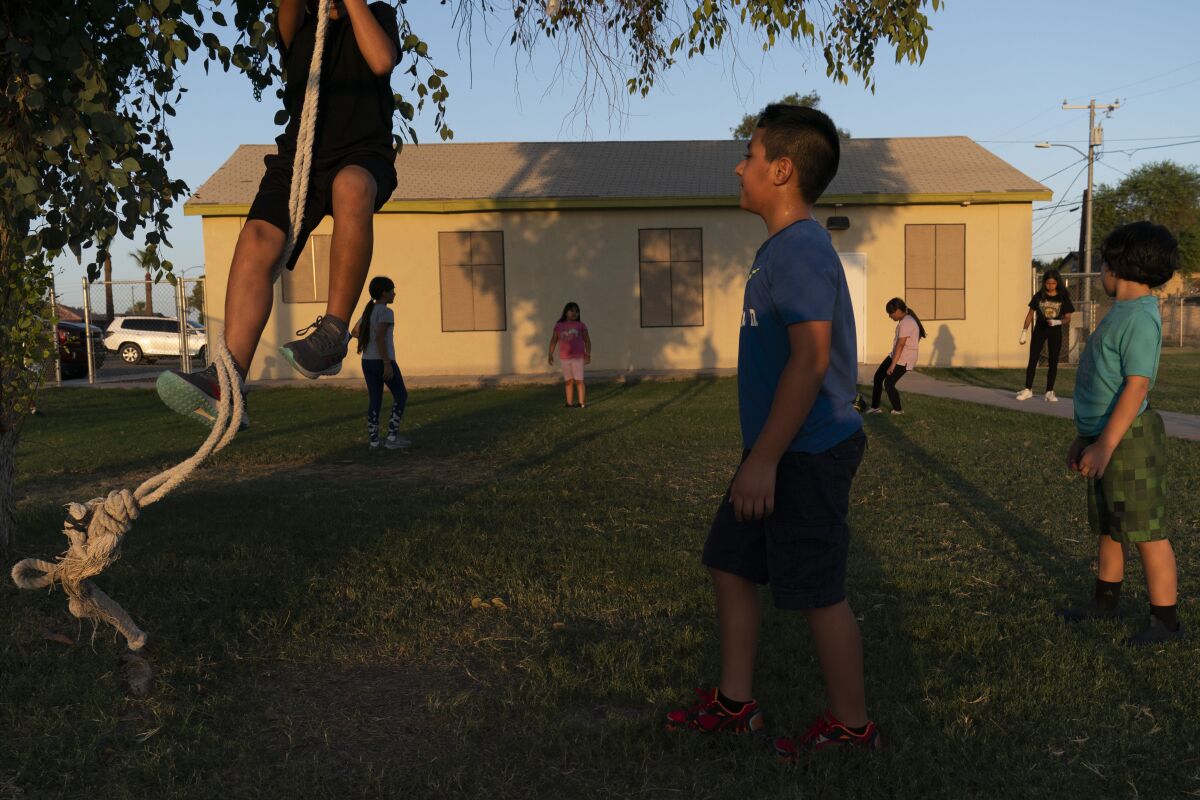 Children play in the yard of a community boxing club in Somerton, Ariz.