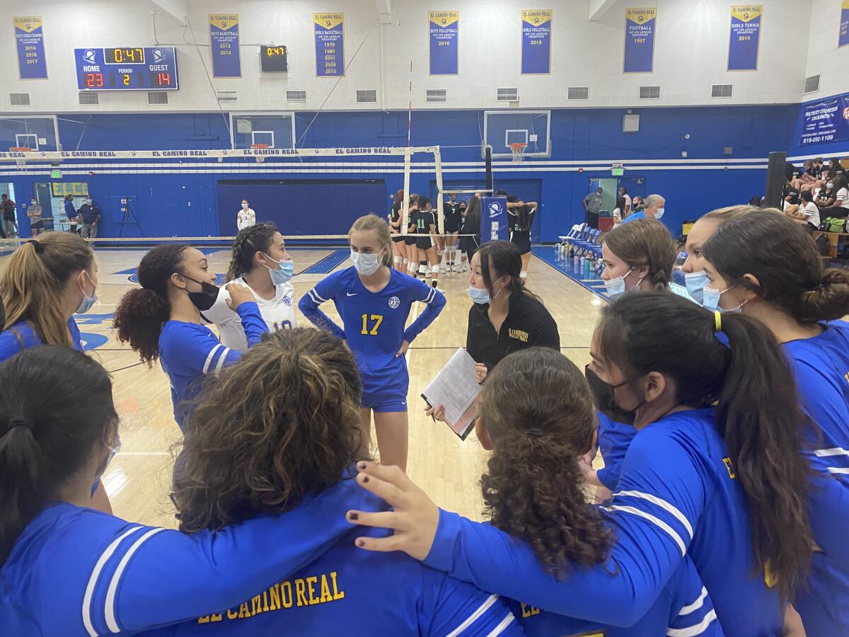 El Camino Real girls' volleyball coach Alyssa Lee talks to team during timeout.