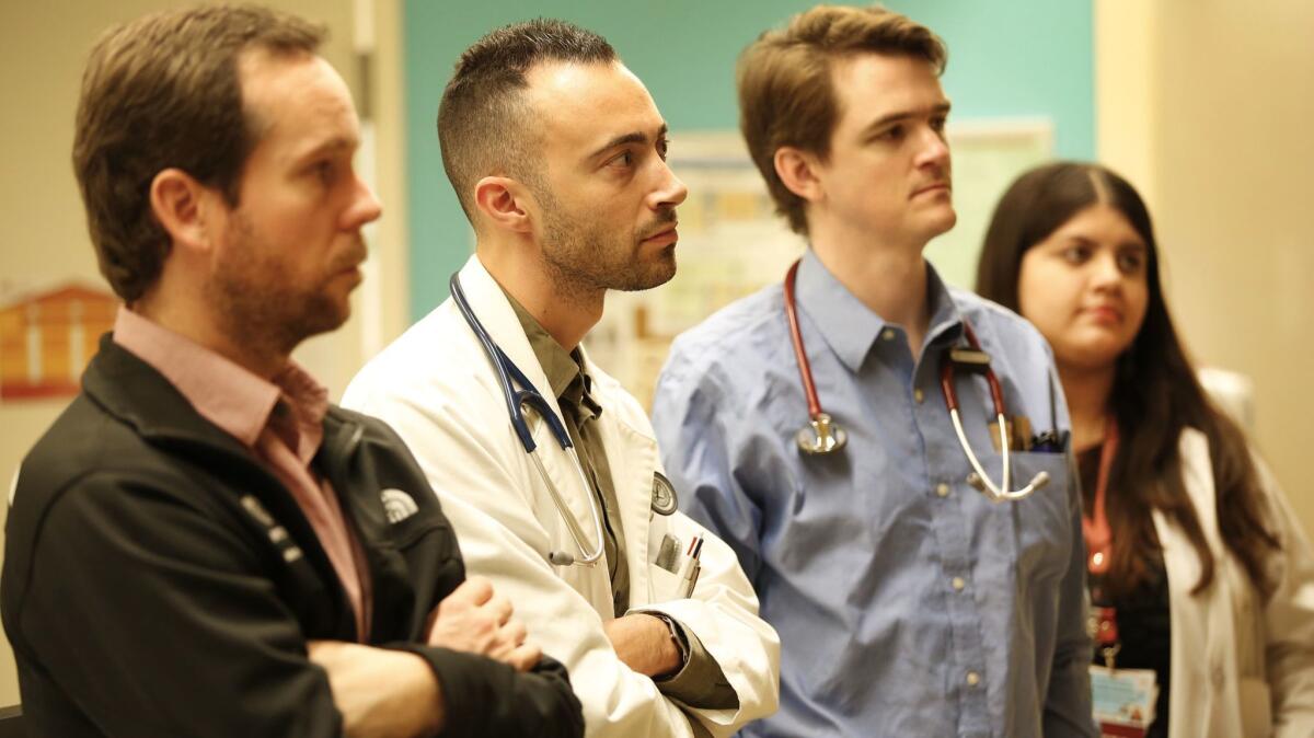 Resident physicians Michael Kendall, Joseph Pawlowski, Eric Stone and Kavita Renduchintala listen to Dr. Jonathan LoPresti as they discuss patient care.