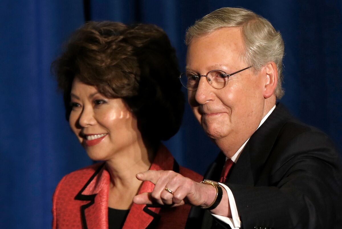 Sen. Mitch McConnell (R-Ky.) and his wife Elaine Chao arrive for a victory celebration following the early results of the state Republican primary in Louisville, Kentucky.
