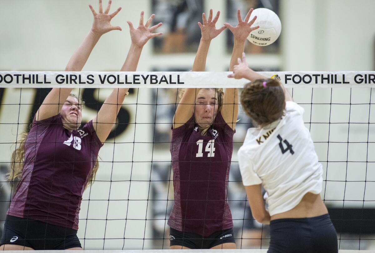 Laguna Beach's Luisa LoFranco, left, and Piper Naess attempt to block a shot from Foothill's Grace Chillingworth in the first round of the CIF State Southern California Regional Division I playoffs on Tuesday in Santa Ana.
