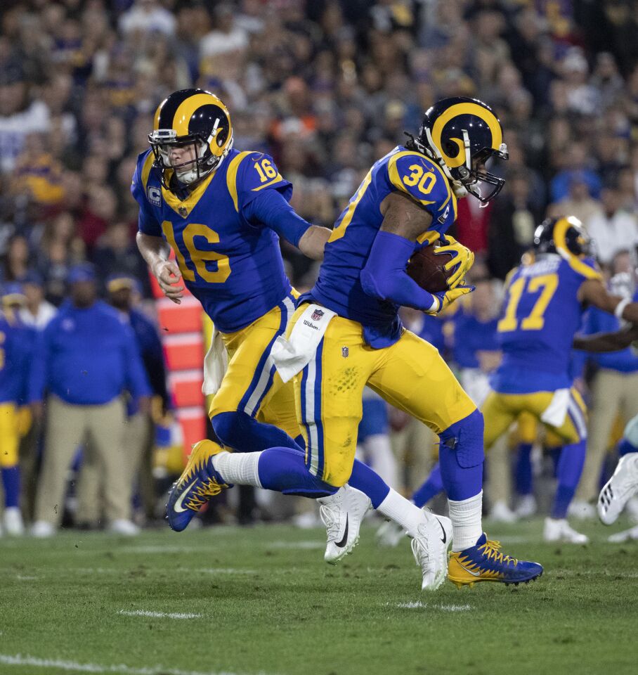 Rams quarterback Jared Goff (16) hands off to running back Todd Gurley (30) during the first half.
