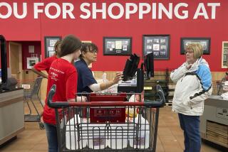 Grocery workers help a costumer at a cash register in Buffalo Grove, Ill., Sunday, March 19, 2023. (AP Photo/Nam Y. Huh)