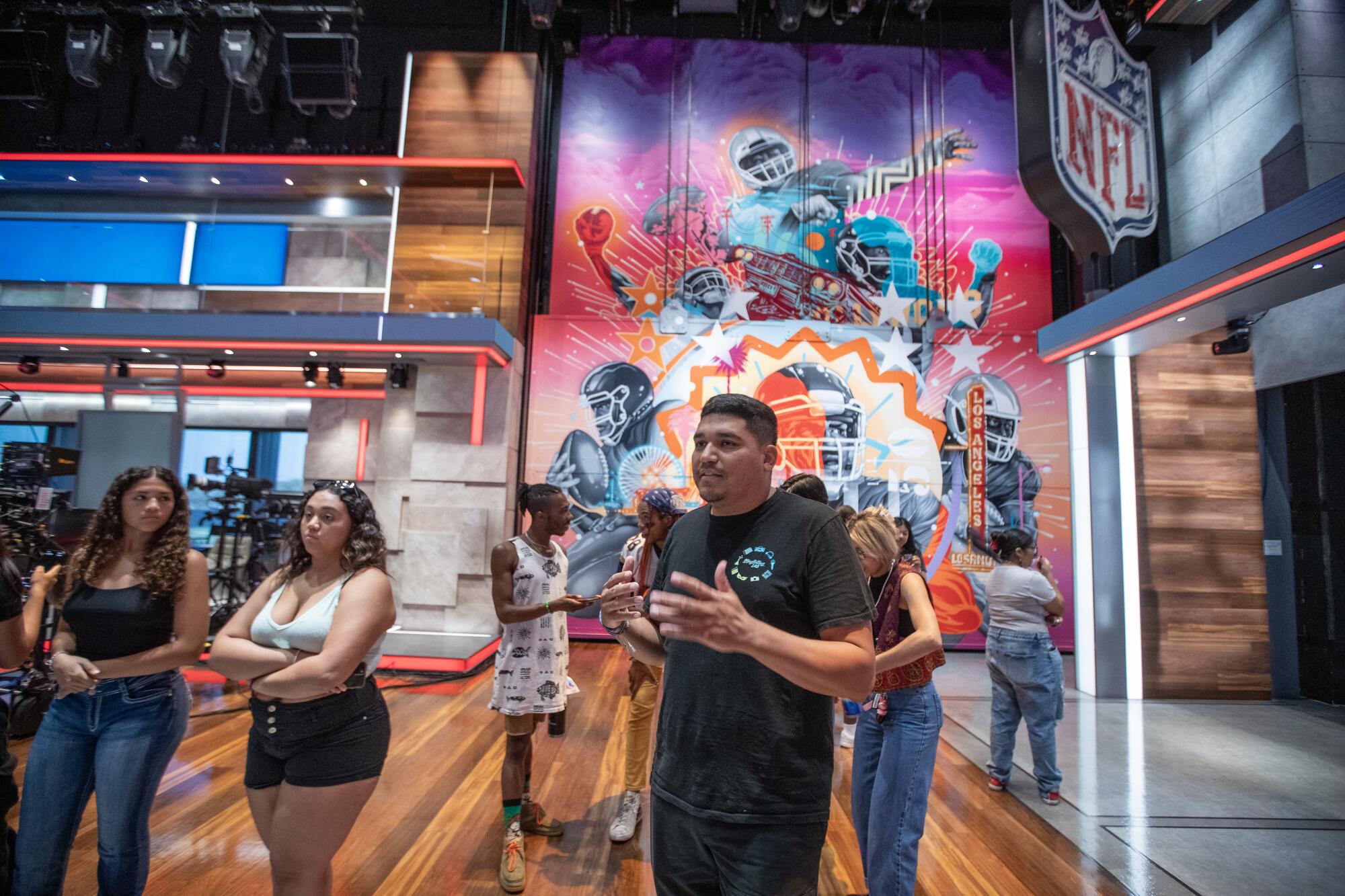 Luis Vasquez, center, co-founder and managing director of Rainbow Labs and students tour NFL Studios in Inglewood