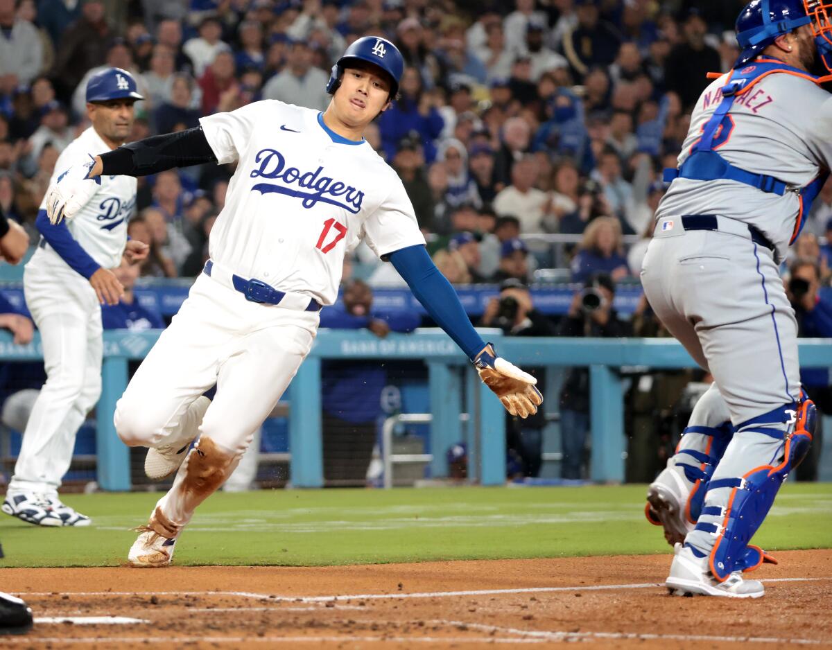 Dodgers star Shohei Ohtani scores a run against the Mets in the fourth inning Friday.