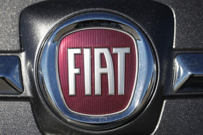 FILE- In this Oc. 21, 2018, file photo the company logo shines off the front of a vehicle at a Fiat dealership in Highlands Ranch, Colo. Fiat Chrysler is voluntarily recalling vehicles in the U.S. because they don't meet the country's emission standards. The Environmental Protection Agency says that the recall is the result of in-use emissions investigations it performed and in-use testing conducted by Fiat Chrysler as required by EPA regulations. (AP Photo/David Zalubowski, File)