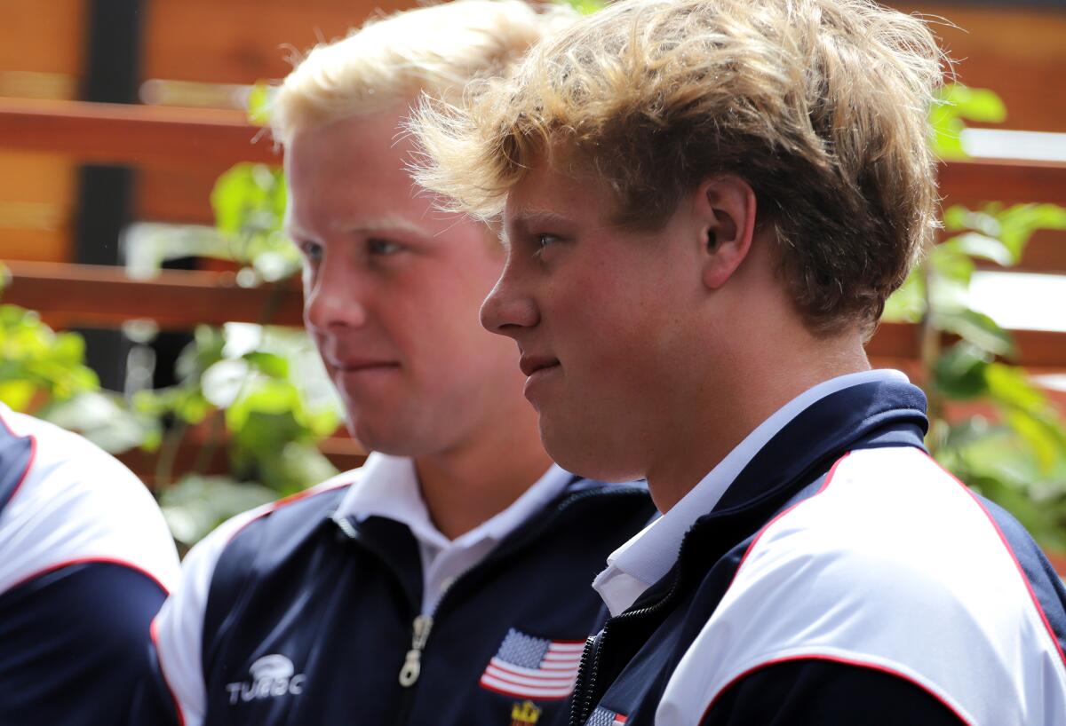 Huntington Beach High School graduate Chase Dodd, left, and his younger brother Ryder Dodd stand  during Tuesday's event.