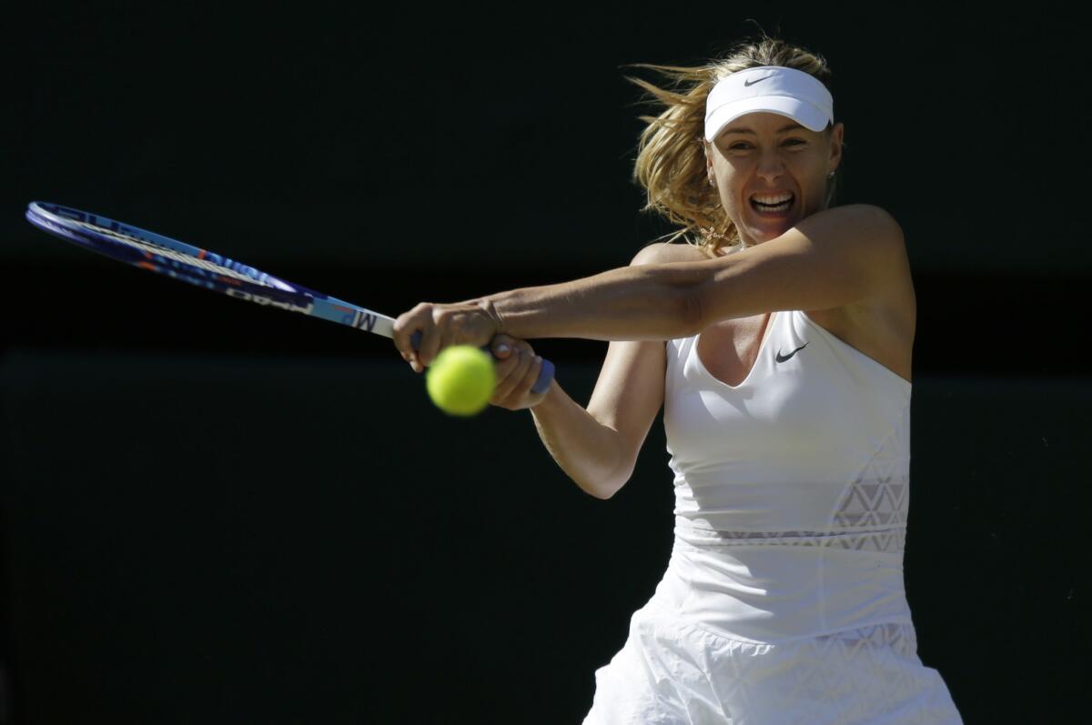 Maria Sharapova returns a shot against Serena Williams during a women's singles semifinal match Wimbledon