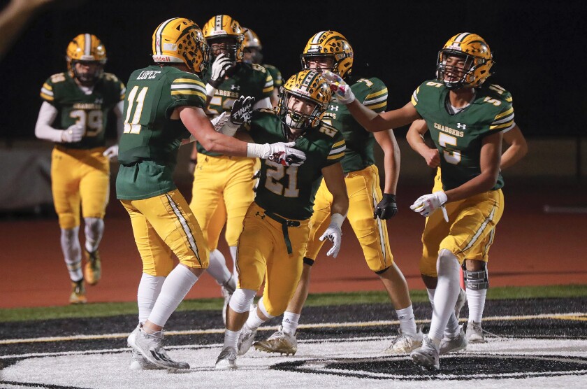 Edison's Troy Fletcher (21) celebrates with teammates after intercepting a pass for a touchdown  against Murrieta Valley.
