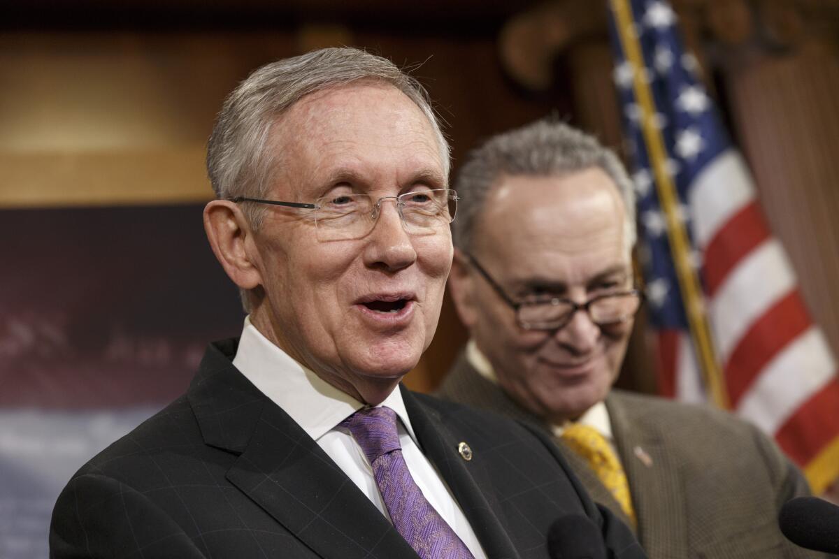 Senate Majority Leader Harry Reid (D-Nev.), left, joined by Sen. Chuck Schumer (D-N.Y.), talks to reporters at the Capitol in this 2013 file photo.