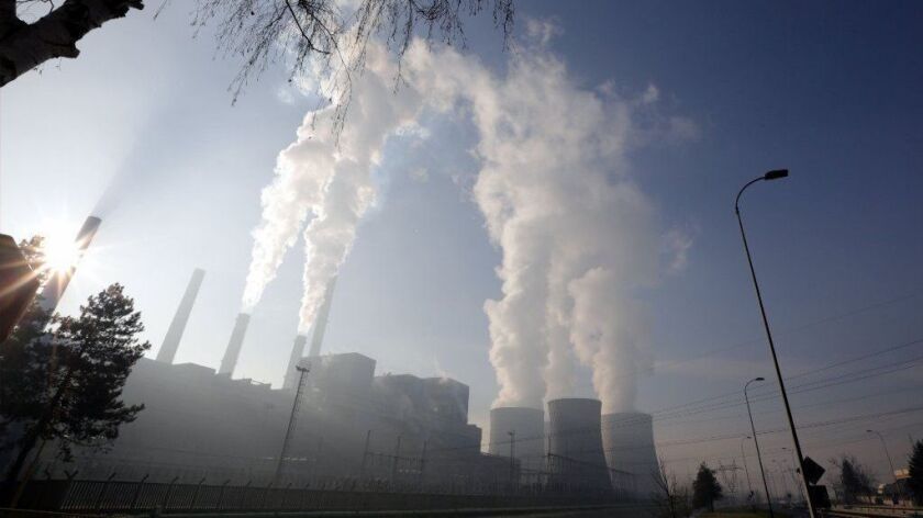 Steam rises from the cooling towers of a coal-fired power plant in Tuzla, Bosnia and Herzegovina, on Dec. 12.