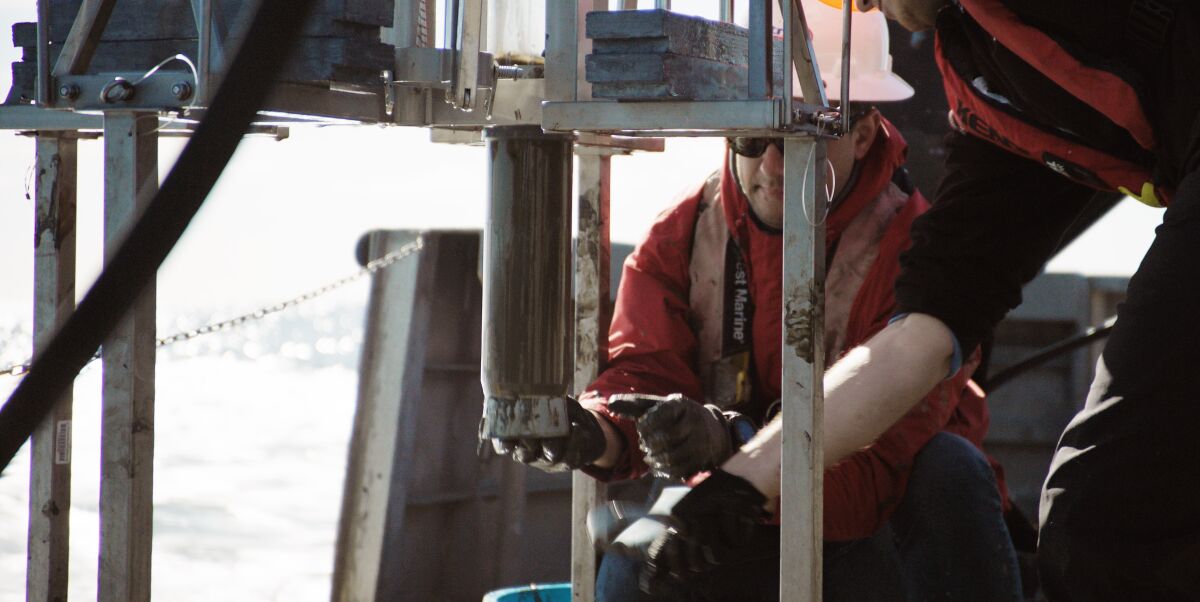 David Valentine and his postdoc bring a sediment sample up from the seafloor.