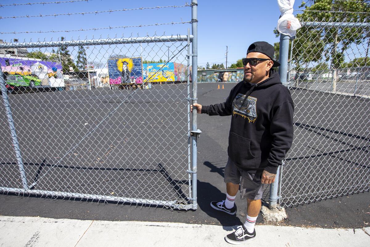 Ruben Salazar closes the gate at the Blue Lot in Santa Ana.