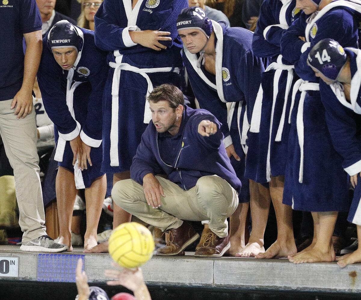 Newport Harbor High coach Ross Sinclair talks with his team during a timeout against Corona del Mar in a Surf League match on Oct. 3, 2018.