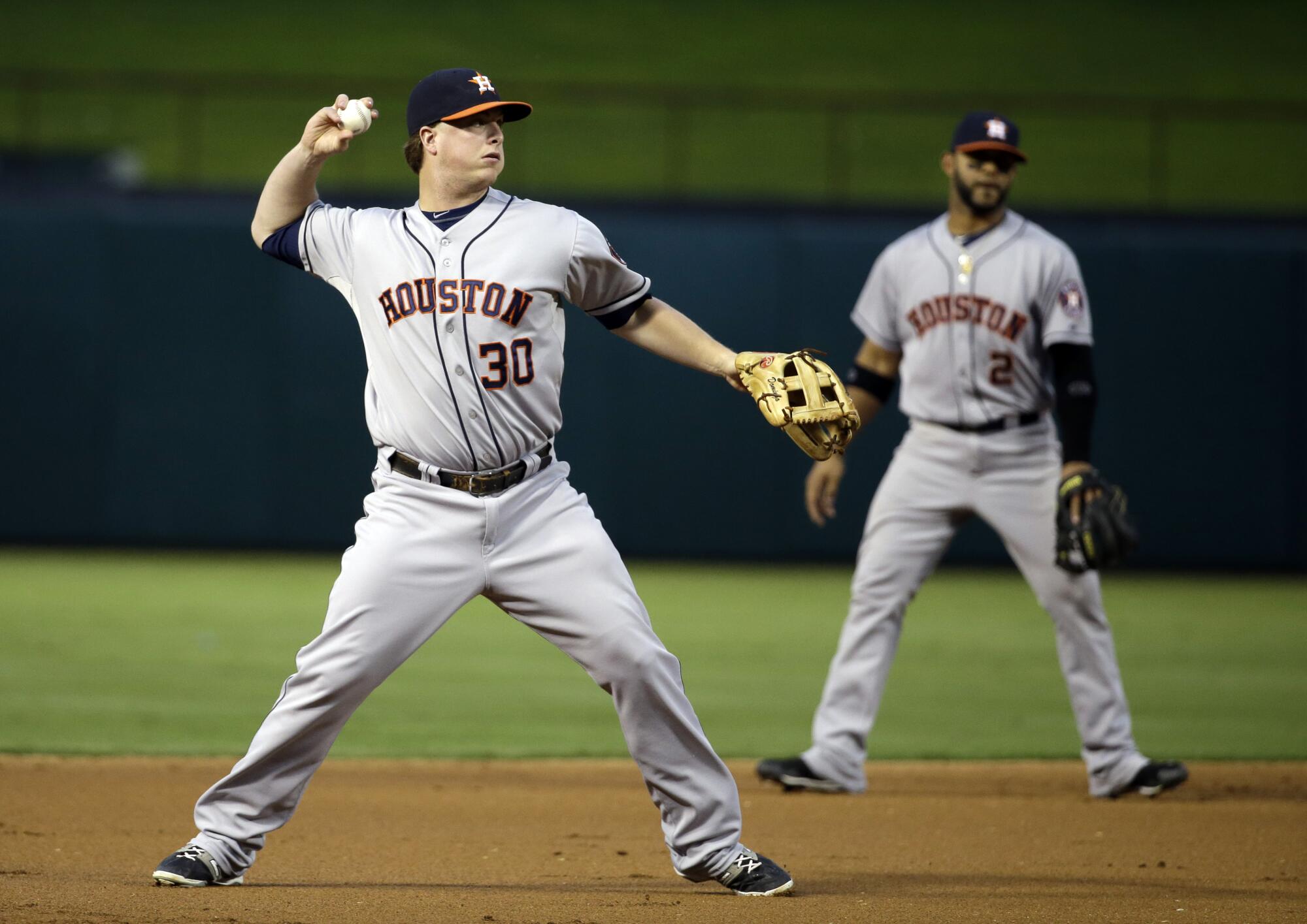 Houston Astros third baseman Matt Dominguez throws to first against the Texas Rangers in September 2014.