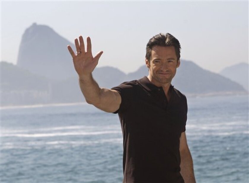 Actor Hugh Jackman greets fans after a press conference at the Forte de Copacabana, back dropped by the Sugar Loaf mountain in Rio de Janeiro, Wednesday, May 6, 2009. Jackman is promoting his new film "X-Men Origins: Wolverine". (AP Photo/Silvia Izquierdo)