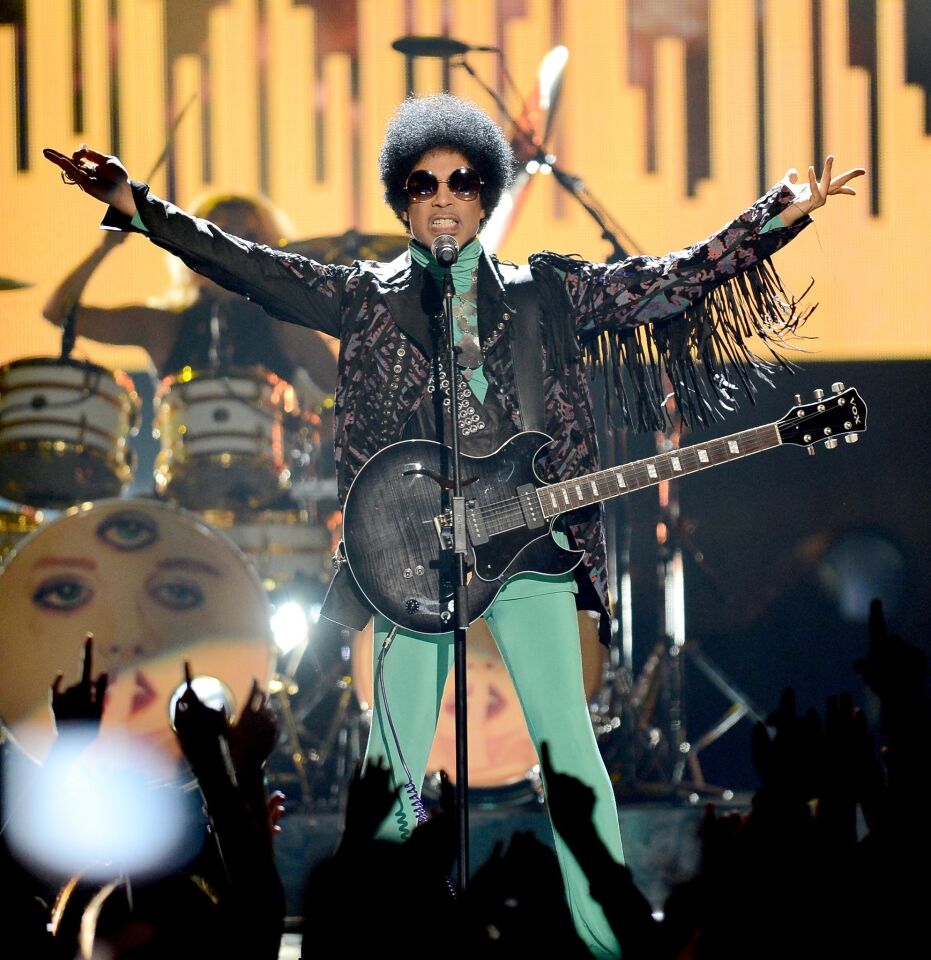 Musician Prince performs onstage during the 2013 Billboard Music Awards.