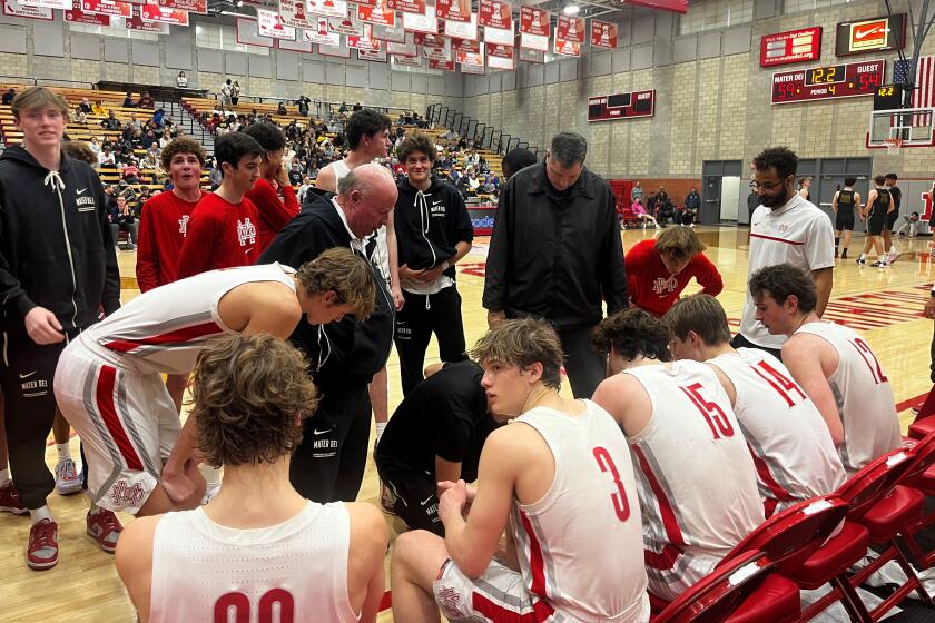 Mater Dei players listen to instructions during a timeout during a playoff game against Mira Costa.
