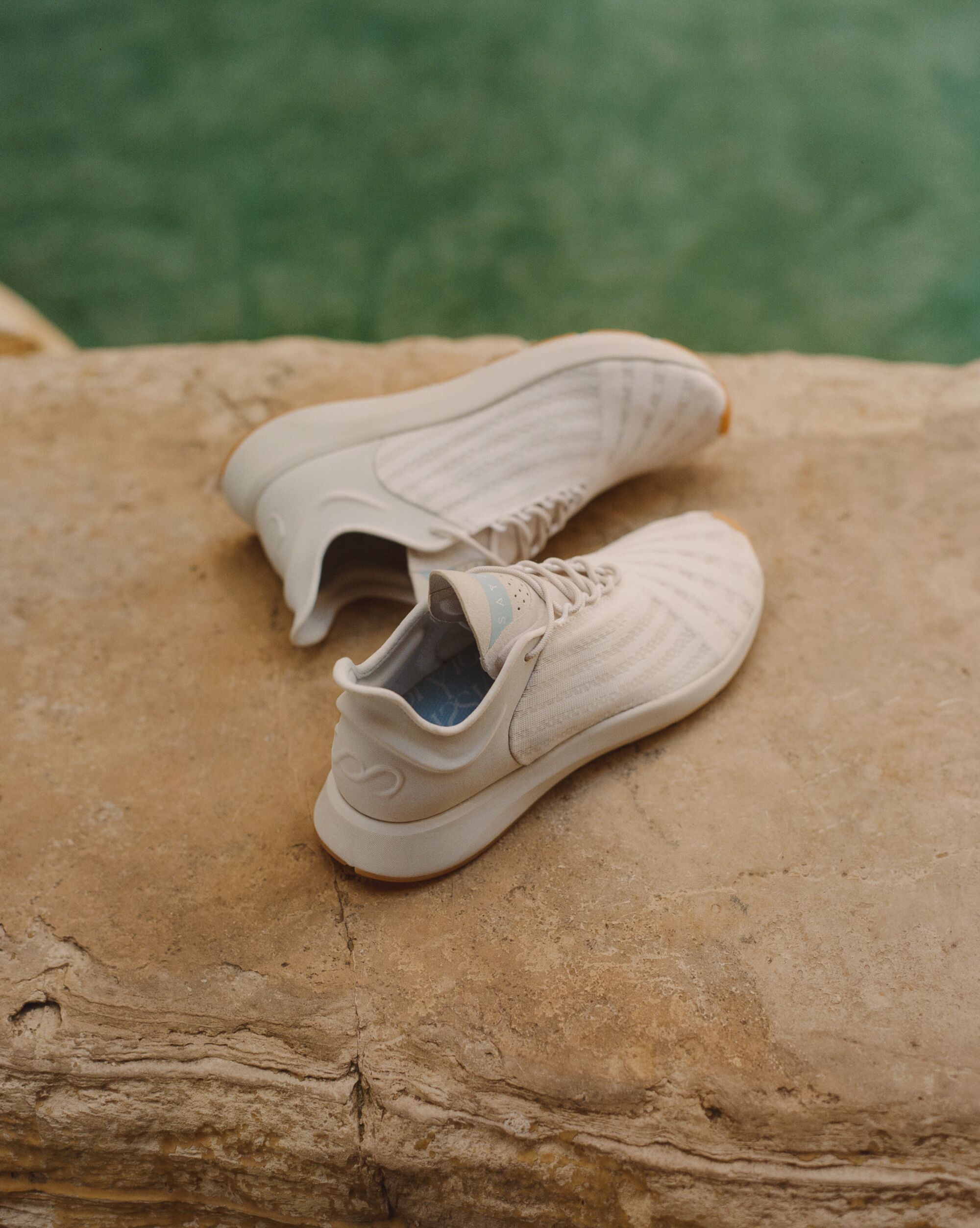 White sneakers on a rock.