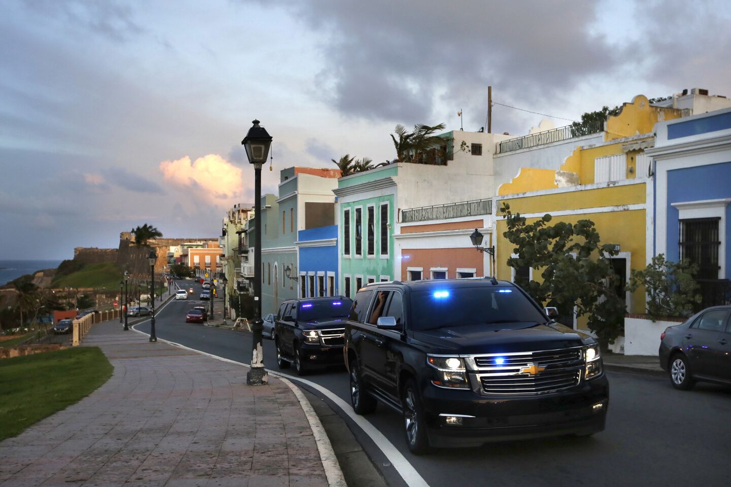 Official cars with loudspeakers roll slowly down a street in Old San Juan, Puerto Rico, broadcasting a warning to residents to evacuate as Hurricane Maria approaches.