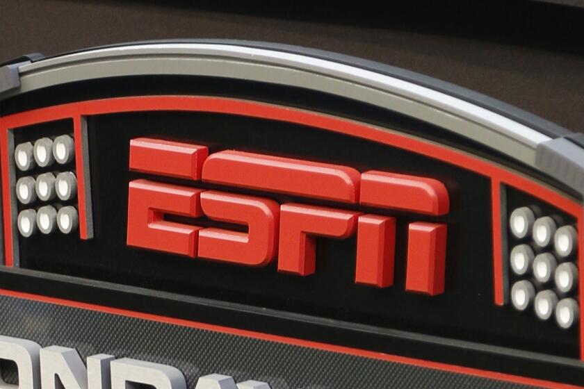 FILE - In this Sept. 16, 2013, file photo, an ESPN logo is seen prior to an NFL football game between the Cincinnati Bengals and the Pittsburgh Steelers in Cincinnati. The network will air the inaugural Overwatch League Grand Finals in prime time this month as part of a multiyear agreement to bring esports to the biggest sports platform on American television. Disney and Blizzard Entertainment announced plans Wednesday, July 11, 2018, to broadcast the OWL’s playoffs and championship on ESPN, ABC and Disney XD. The Grand Finals on July 27 and 28 will be shown live on ESPN, marking the first time the network will carry esports in prime time. (AP Photo/David Kohl, File)