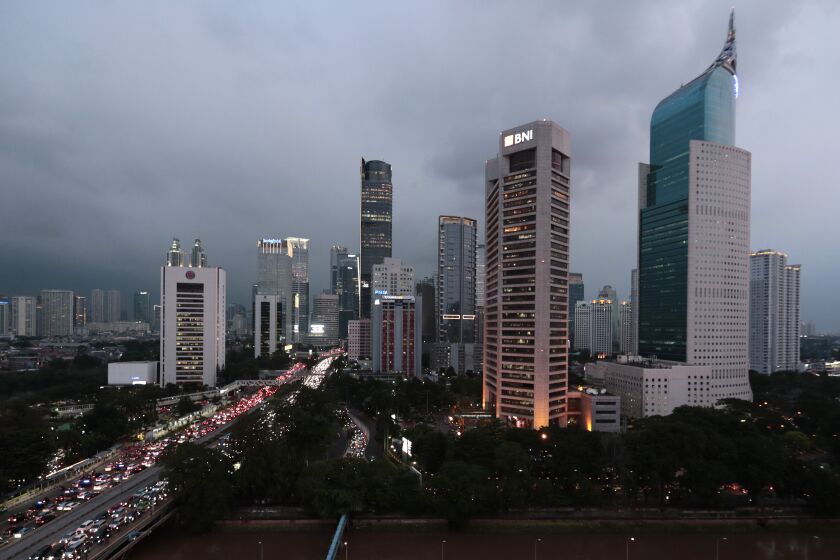 FILE - The central business district skyline is seen during the dusk in Jakarta, Indonesia, Monday, April 29, 2019. Indonesia’s Parliament has passed a long-awaited and controversial revision of its penal code, Tuesday, Dec. 6, 2022, that criminalizes extramarital sex and applies to citizens and visiting foreigners alike. (AP Photo/Dita Alangkara, File)