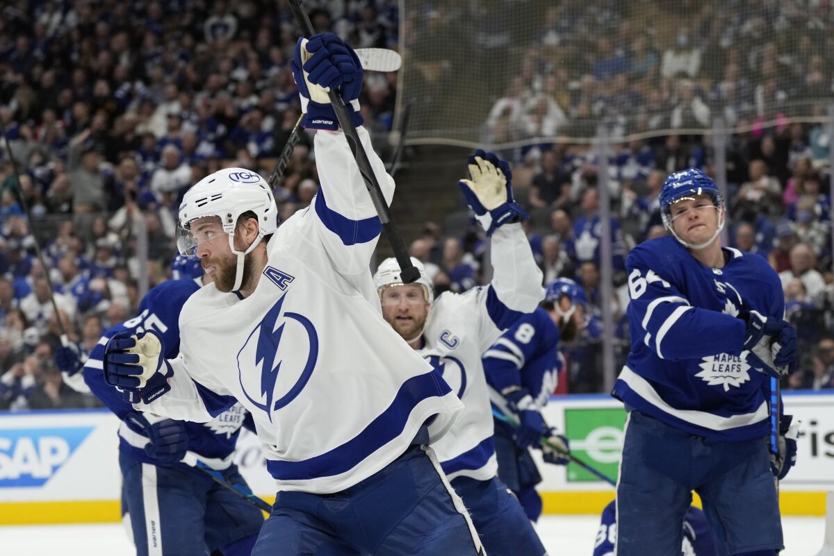 Tampa Bay Lightning defenseman Victor Hedman (77) celebrates his goal against the Toronto Maple Leafs with center Steven Stamkos (91) during the first period of Game 2 of an NHL hockey Stanley Cup playoffs first-round series Wednesday, May 4, 2022, in Toronto. (Frank Gunn/The Canadian Press via AP)