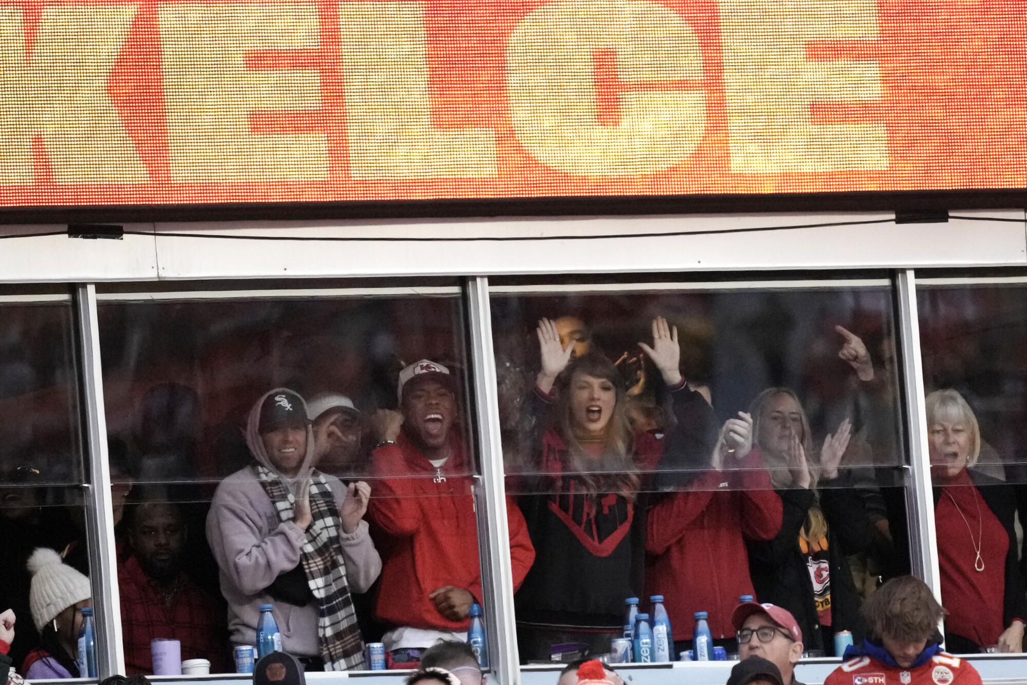 Taylor Swift watches from a suite during a game between the Kansas City Chiefs and Buffalo Bills in December.