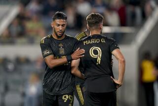 Los Angeles FC forward Denis Bouanga, left, greets forward Mario González.