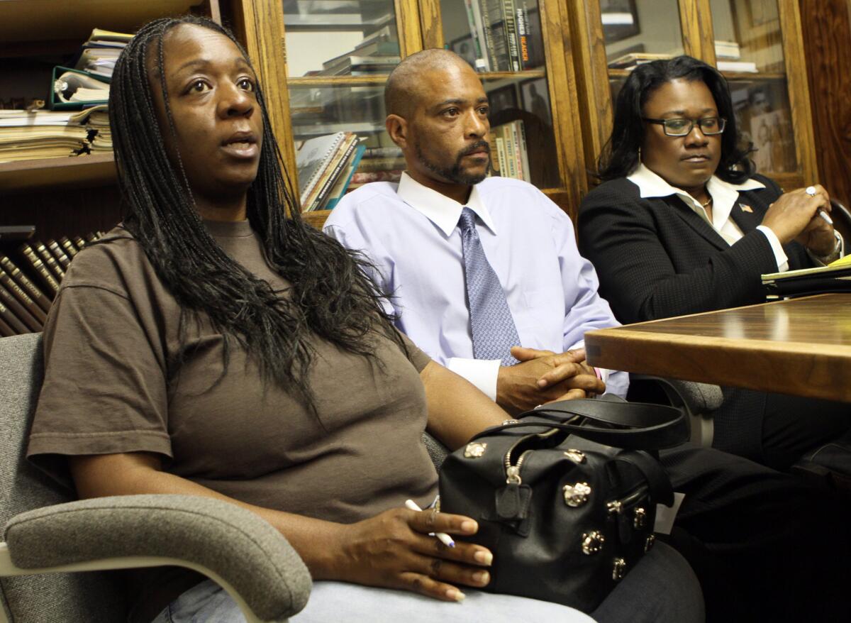 Anya Slaughter, left, and Kenneth McDade, parents of Kendrec McDade, speak to reporters in 2012, accompanied by attorney Caree Harper.