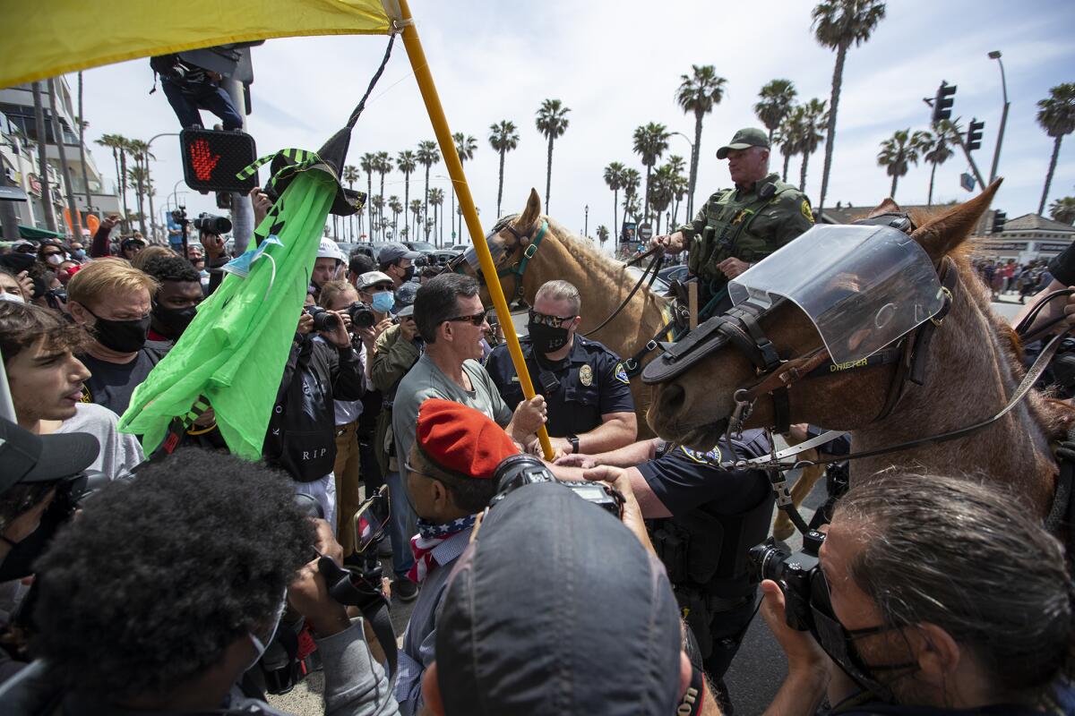 A Trump supporter is arrested during Sunday's rally in Huntington Beach.