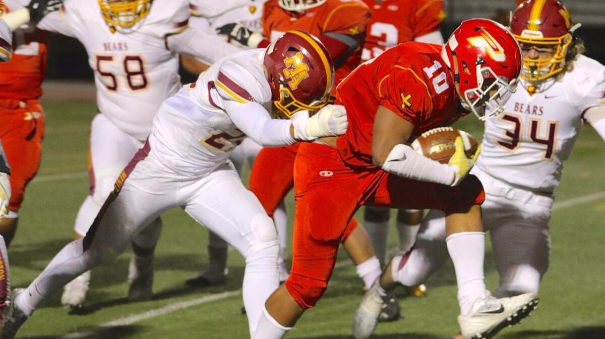 K.J. Latu crosses the goal line for the first of his three touchdowns in Paraclete's 39-21 victory over Menlo-Atherton in the CIF state Division 3-AA championship bowl game on Dec. 17.