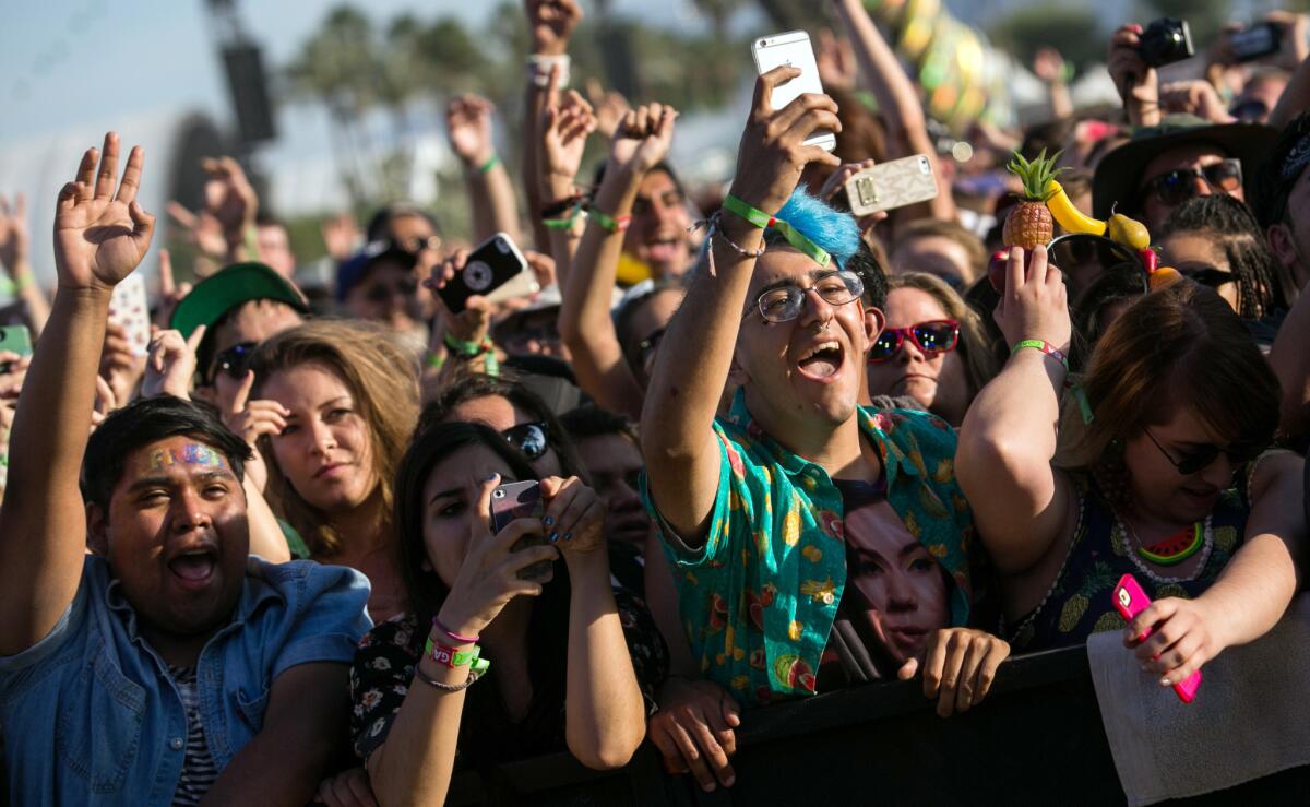 Music fans hold up their phones to record at the Coachella Valley Music and Arts Festival in Indio on April 19.