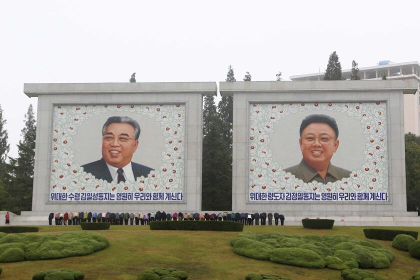 Citizens visit the portraits of the country's late leaders Kim Il Sung and Kim Jong Il on the occasion of the 78th founding anniversary of the Worker's Party of Korea in Pyongyang, North Korea Tuesday, Oct. 10, 2023. (AP Photo/Jon Chol Jin)