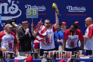Patrick Bertoletti celebrates after winning the men's division of Nathan's Famous Fourth of July hot dog eating contest 