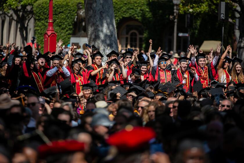 LOS ANGELES, CA - MAY 13: Graduates stand up and cheer as their school is announced at The University of Southern California's 2022 commencement ceremony on Friday, May 13, 2022 in Los Angeles, CA. (Jason Armond / Los Angeles Times)