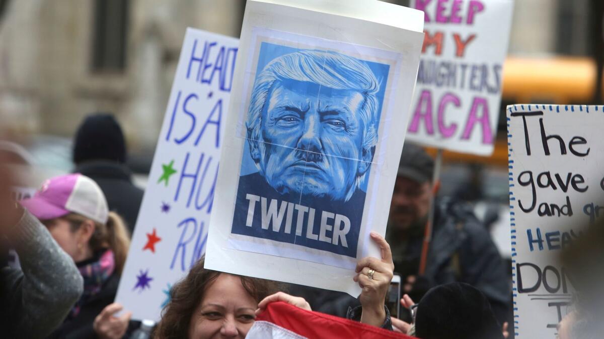 A demonstrator holds up a sign comparing Donald Trump to Hitler at a protest march in Philadelphia on Jan. 26.