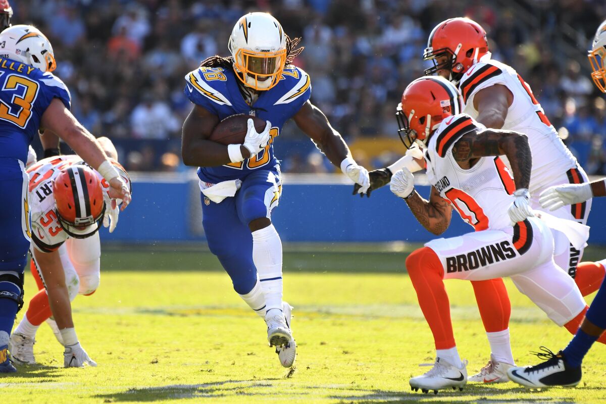 The Chargers' Melvin Gordon finds running room in the middle of the line.
