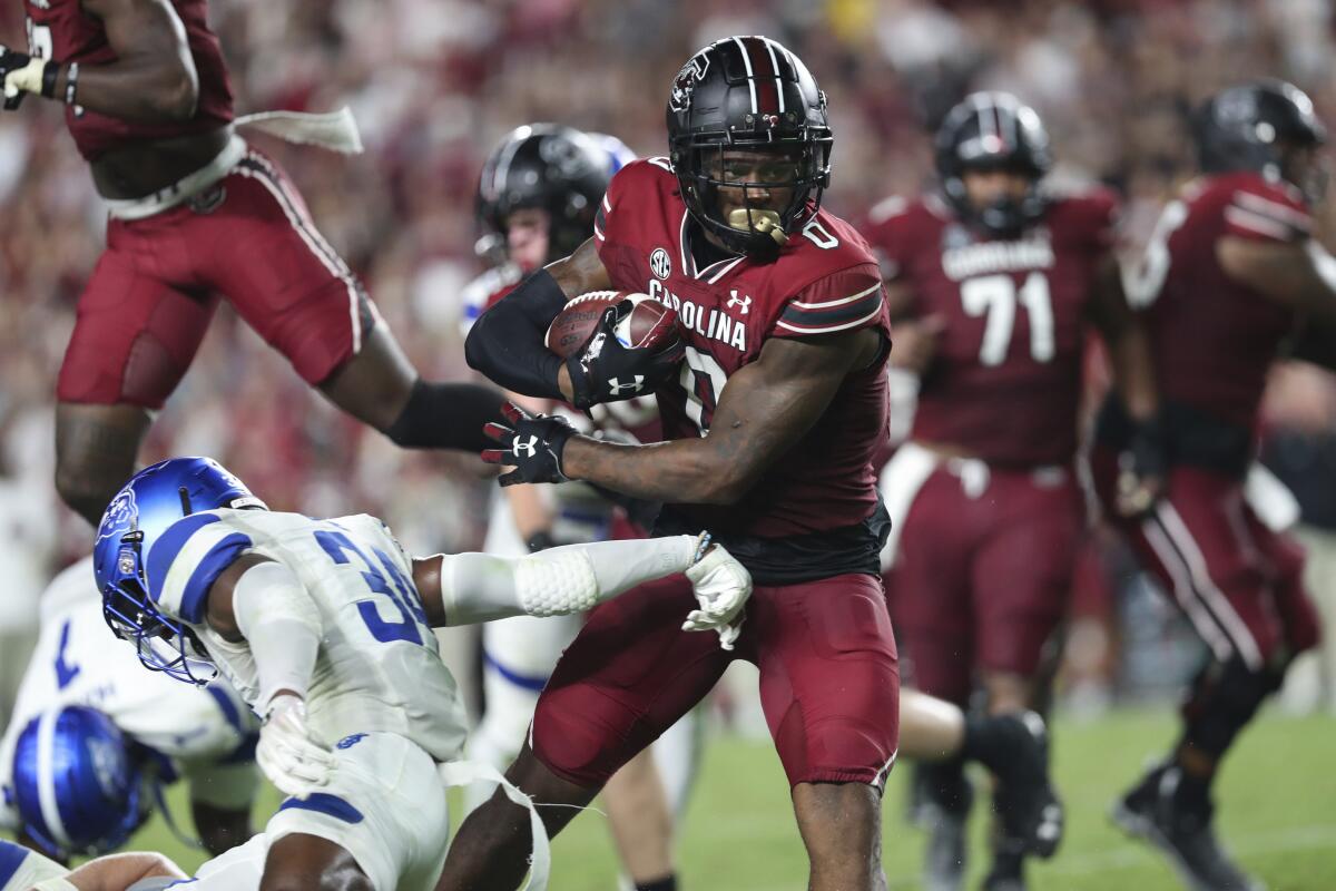 South Carolina tight end Jaheim Bell (0) pushes off Georgia State safety Antavious Lane (34) during an NCAA college football game Saturday, Sept. 3, 2022, in Columbia, S.C. (AP Photo/Artie Walker Jr.)