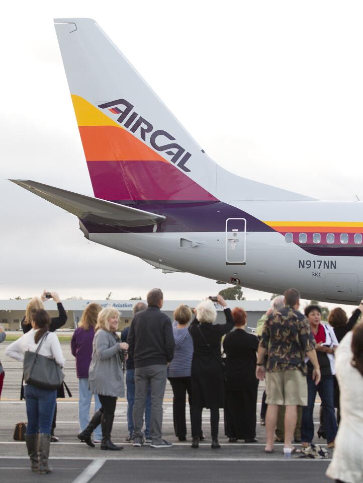 Employees of the former AirCal airlines gather on the tarmac at John Wayne Airport.