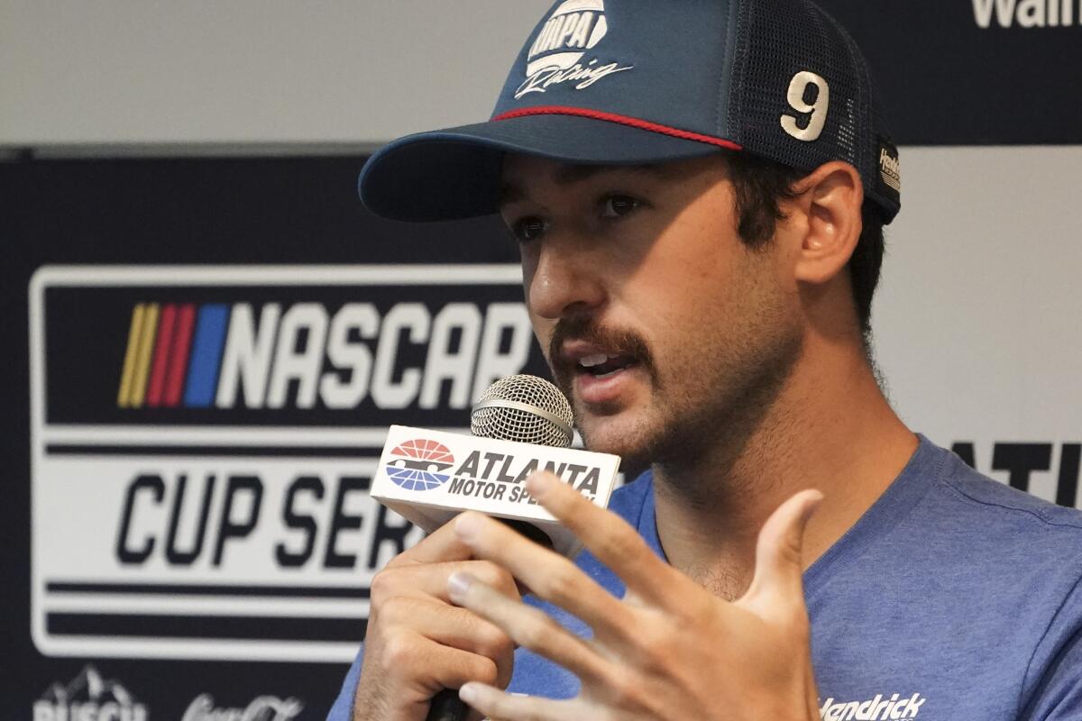 Driver Chase Elliott speaks to the media during a weather delay before qualifying the NASCAR Cup Series auto race at Atlanta Motor Speedway in Hampton, Ga., on Saturday, July 9, 2022. (AP Photo/Bob Andres)