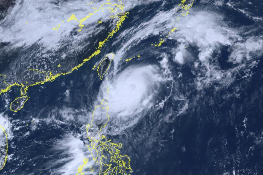This satellite image taken by Himawari-8, a Japanese weather satellite, and provided by National Institute of Information and Communications Technology, shows Typhoon Koinu, center, approaching Taiwan Tuesday, Oct. 3, 2023. (Courtesy of National Institute of Information and Communications Technology (NICT) via AP)