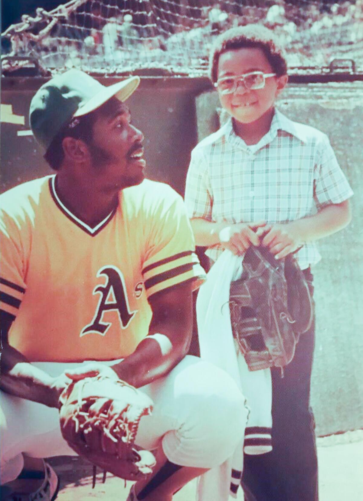 Derrick Blue, right, with his father, former Oakland Athletics pitcher Vida Blue