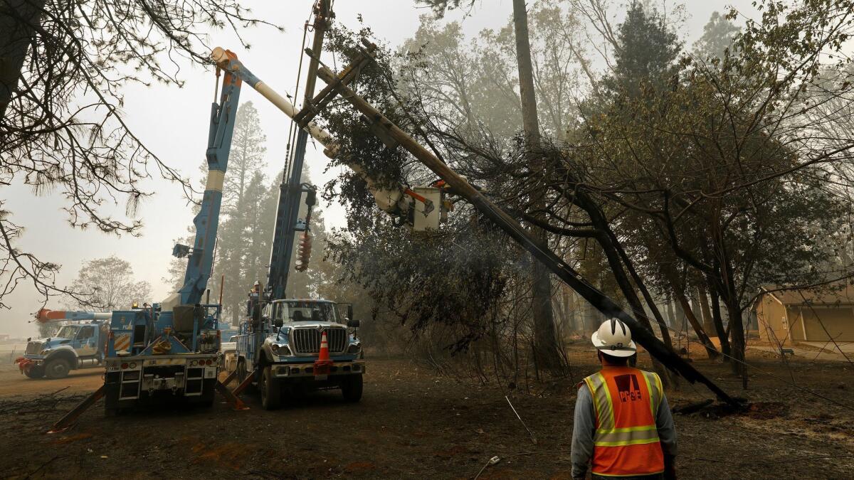 Crews work on power lines after the Camp fire, the deadliest and most destructive wildfire in state history. The November fire in Butte County in Northern California could push PG&E into bankruptcy.