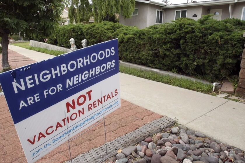 The Save San Diego Neighborhoods alliance presses for more regulation of short-term vacation rentals with signs posted on resident’s yards.