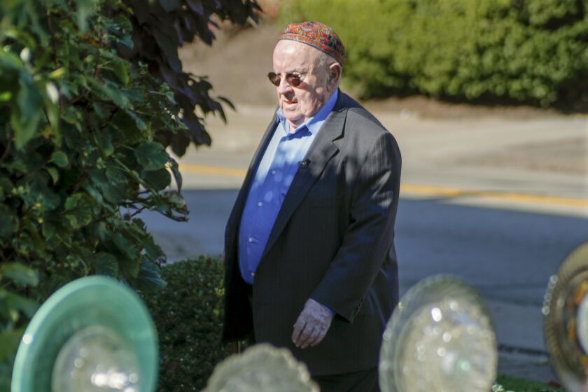 FILE - Holocaust survivor Judah Samet walks around the Tree of Life Synagogue, on Oct. 24, 2019 in the Squirrel Hill neighborhood of Pittsburgh. Samet, a Holocaust survivor who narrowly escaped a shooting rampage at a Pittsburgh synagogue in 2018, died Tuesday, Sept. 27, 2022. He was 84. (AP Photo/Keith Srakocic, File)