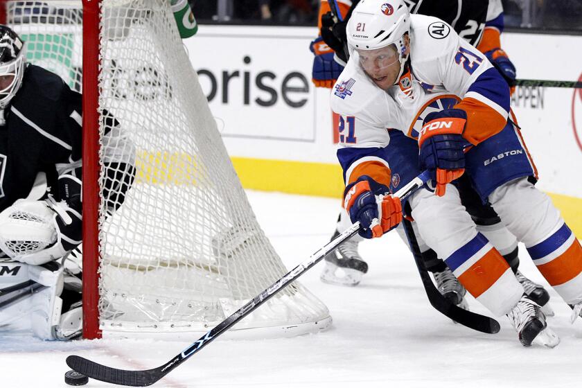 Kings goalie Jhonas Enroth is poised to stop a wrap-around attempt by Islanders right wing Kyle Okposo in the first period Thursday night.
