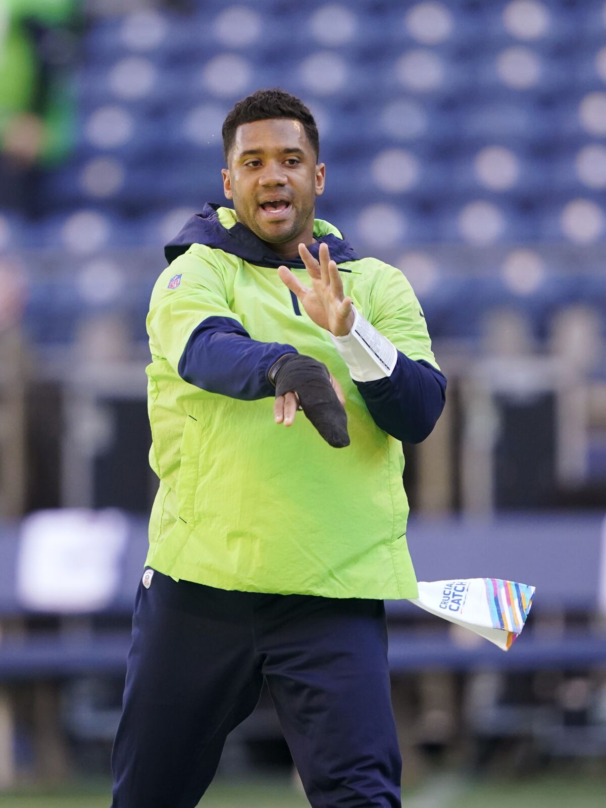Seattle Seahawks injured quarterback Russell Wilson mimics a throwing motion before an NFL football game against the Jacksonville Jaguars, Sunday, Oct. 31, 2021, in Seattle. (AP Photo/Ted S. Warren)